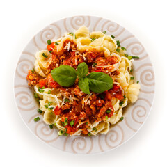 Pasta with meat and tomato sauce on white background