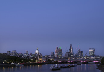 Fototapeta na wymiar skyscrapers in london city with st paul's cathedral at night seen over thames river