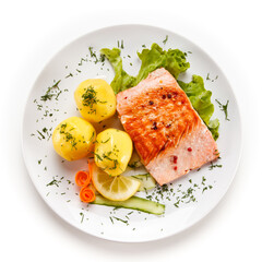 Roast salmon with potatoes on white background