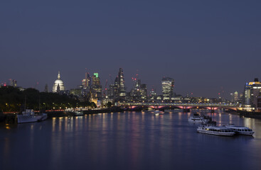 Fototapeta na wymiar skyscrapers in london city with st paul's cathedral at night seen over thames river