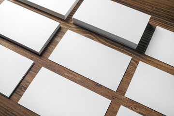 Photo of blank business cards on wooden background. Template for placing your design. Responsive design mockup.
