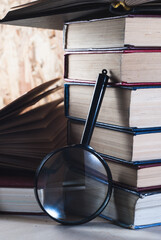 Magnifying glass and books,