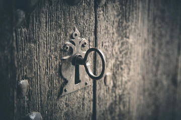 Rustic wooden door with old key