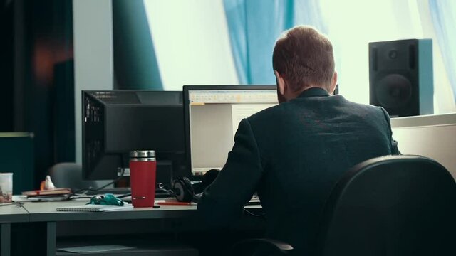 A man is working at a computer in the office