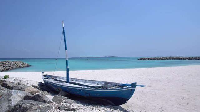 Perfect wild sandy Maldives beach with sailing boat on turquoise sea background, nobody, travel destinations 