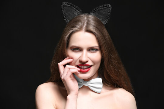 Sexy beautiful woman with cat ears on black background