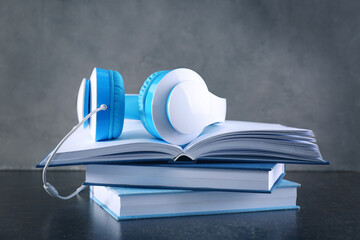 Headphones and books on table. Concept of audiobook