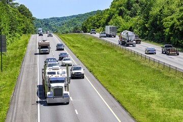 A steady mix of trucks, cars and SUVs roll down an interstate highway in eastern Tennessee.  Heat...