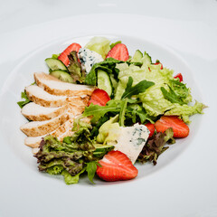 Spring salad with vegetables, strawberries and chicken