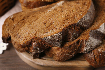Delicious sliced rye bread on cutting board, closeup