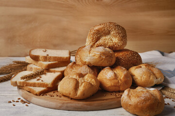 Delicious loaves of bread on wooden cutting board
