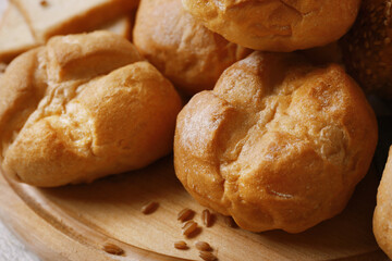 Delicious bread on wooden cutting board, closeup