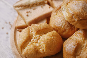 Delicious bread on wooden cutting board, closeup