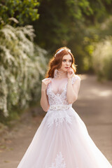 Fototapeta na wymiar Beautiful redhead Bride. Portrait outdoor in sunset light. Pretty young caucasian redhead girl