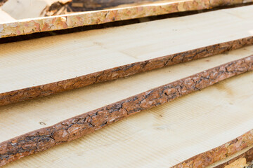 cut the peeled wood, boards, building materials close-up
