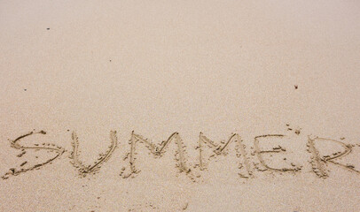 The word "summer" on the sand of the beach