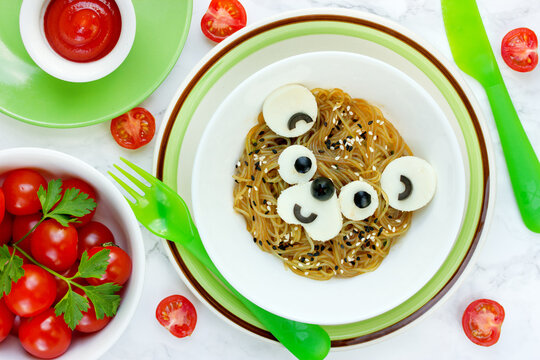 Japanese pasta yakisoba with tofu, sesame and olives shaped bear face