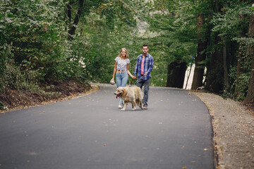 couple walking outdoors with her dog