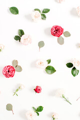 Floral pattern made of red and beige roses, green leaves, branches on white background. Flat lay, top view. Valentine's background. Pattern of flowers. Texture