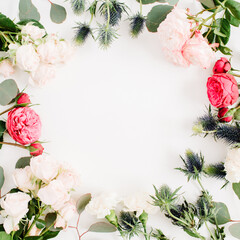 Round frame wreath made of red and beige rose flowers, eringium flower, eucalyptus branches and leaves isolated on white background. Flat lay, top view. Floral background