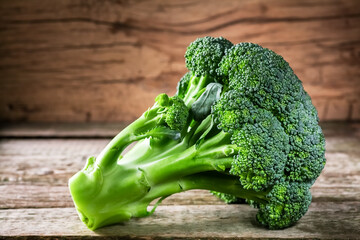 Fresh broccoli on a dark wooden background, top view