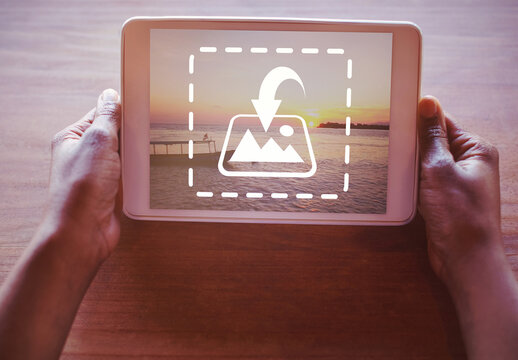 User Holding Tablet on Table Mockup