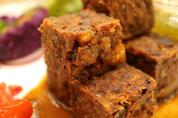 Closed up crispy deep fried minced pork cubes with spicy sauce, with selective focus  