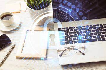 Business workplace with laptop coffee cup and security concept o