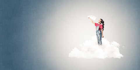 Concept of careless happy childhood with girl dreaming to become