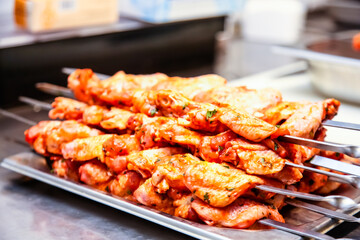The chicken pieces put on a skewer for cooking shish kebab.
