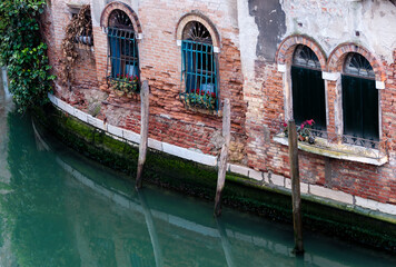Deteriorating building detail on canal, Venice, Italy