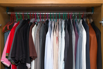 men simple clothing in the wardrobe of the many kind and colored clothes