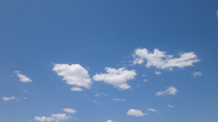 Puffy Clouds in Bright Blue Sky