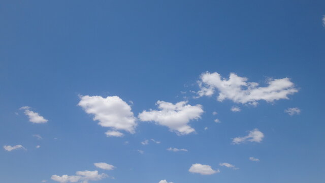 Puffy Clouds in Bright Blue Sky