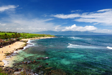 Famous Hookipa beach, popular surfing spot filled with a white sand beach, picnic areas and pavilions. Maui, Hawaii.