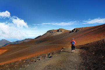 Tourist hiking in Haleakala volcano crater on the Sliding Sands trail.