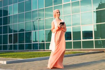 Fototapeta na wymiar pretty modern Arabian woman with tablet computer outdoors