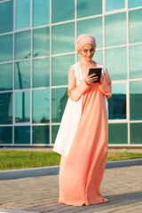 Fototapeta na wymiar pretty modern Arabian woman with tablet computer outdoors