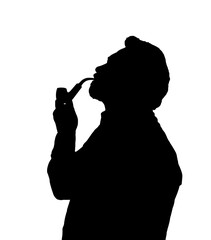 Silhouette of bearded man smoking pipe looking up