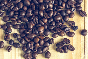 coffee beans on wooden background with effect filter.