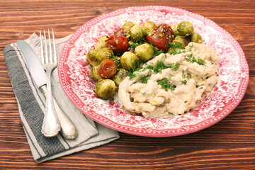 Tasty chicken meat under creamy sauce with brussels sprouts garn