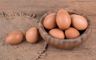 eggs in a wooden bowl on wooden floor