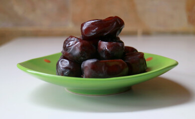 Dates palm fruit on the plate.