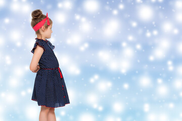 Little girl in blue polka dot dress.