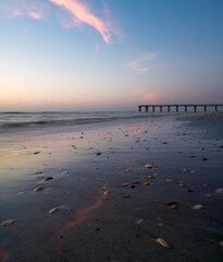 Quiet sunrise over ocean pier and beach in St Augustine, Florida