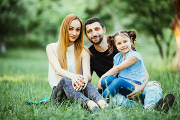 Family in green nature together in summer park