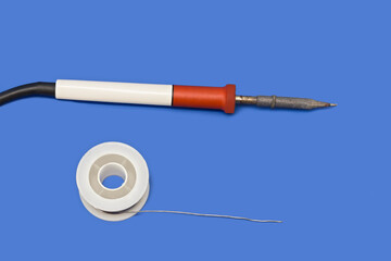 Soldering iron weldingon blue background