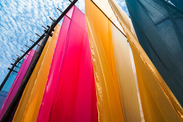 colorful fabric hanging to dry after traditional dye process,shot in Heng Dian Town,Zhejiang province of China.
