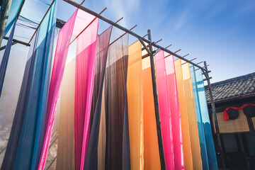 colorful fabric hanging to dry after traditional dye process,shot in Heng Dian Town,Zhejiang province of China.