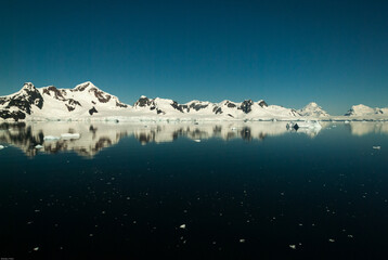 Fototapeta na wymiar Mountain range reflected in Paradise Bay Antarctica